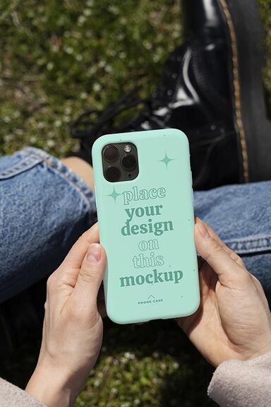 Person holding smartphone mock-up outdoors