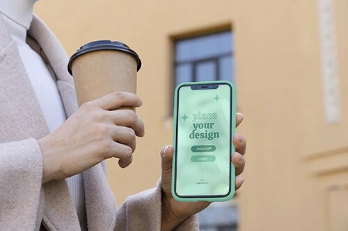 Person holding smartphone mock-up outdoors